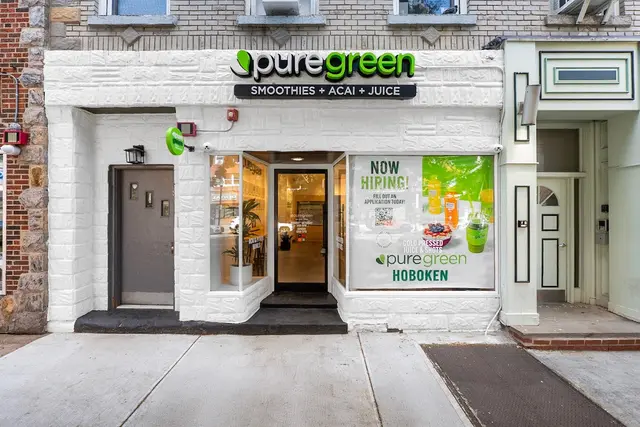 The white brick shopfront of Pure Green Hoboken