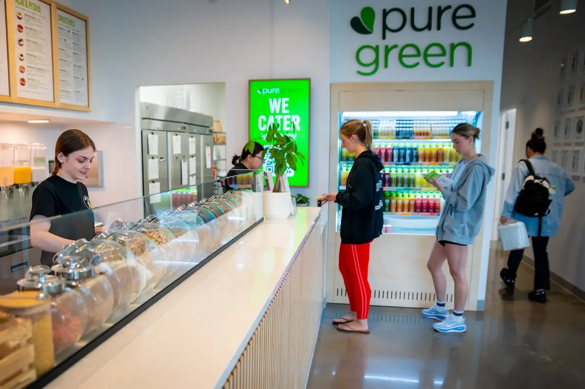 The order counter and cold-pressed juice fridge inside Pure Green Cedar Mill