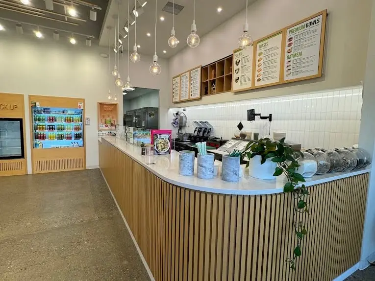 The counter and menu boards at Pure Green Sterling Heights