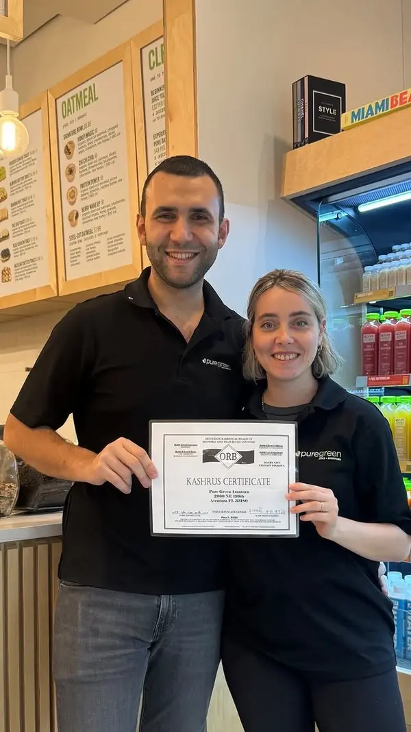 Pure Green Aventura team members with a certificate at the counter