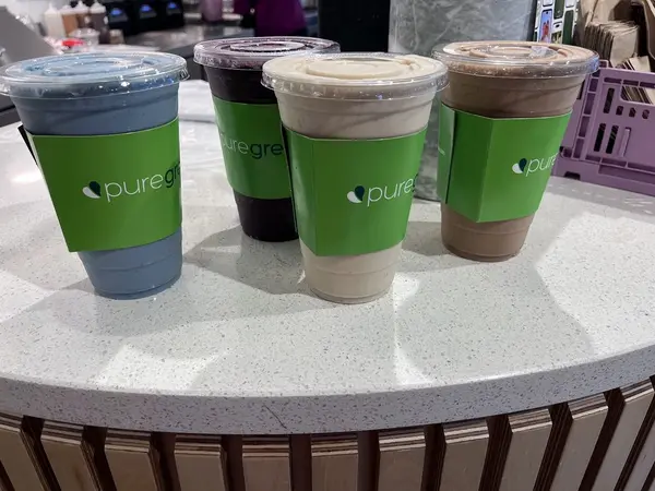 Cold-pressed juices and smoothies lined up at Pure Green Capitol Square