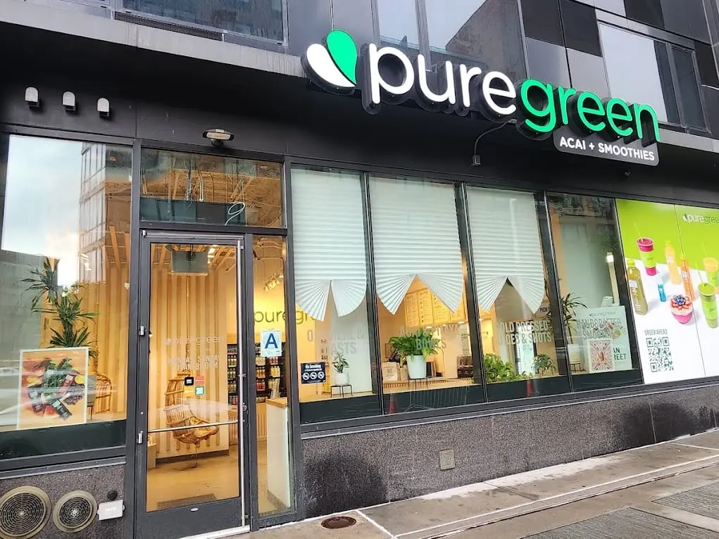 The Pure Green Dean Street corner shopfront seen along the block
