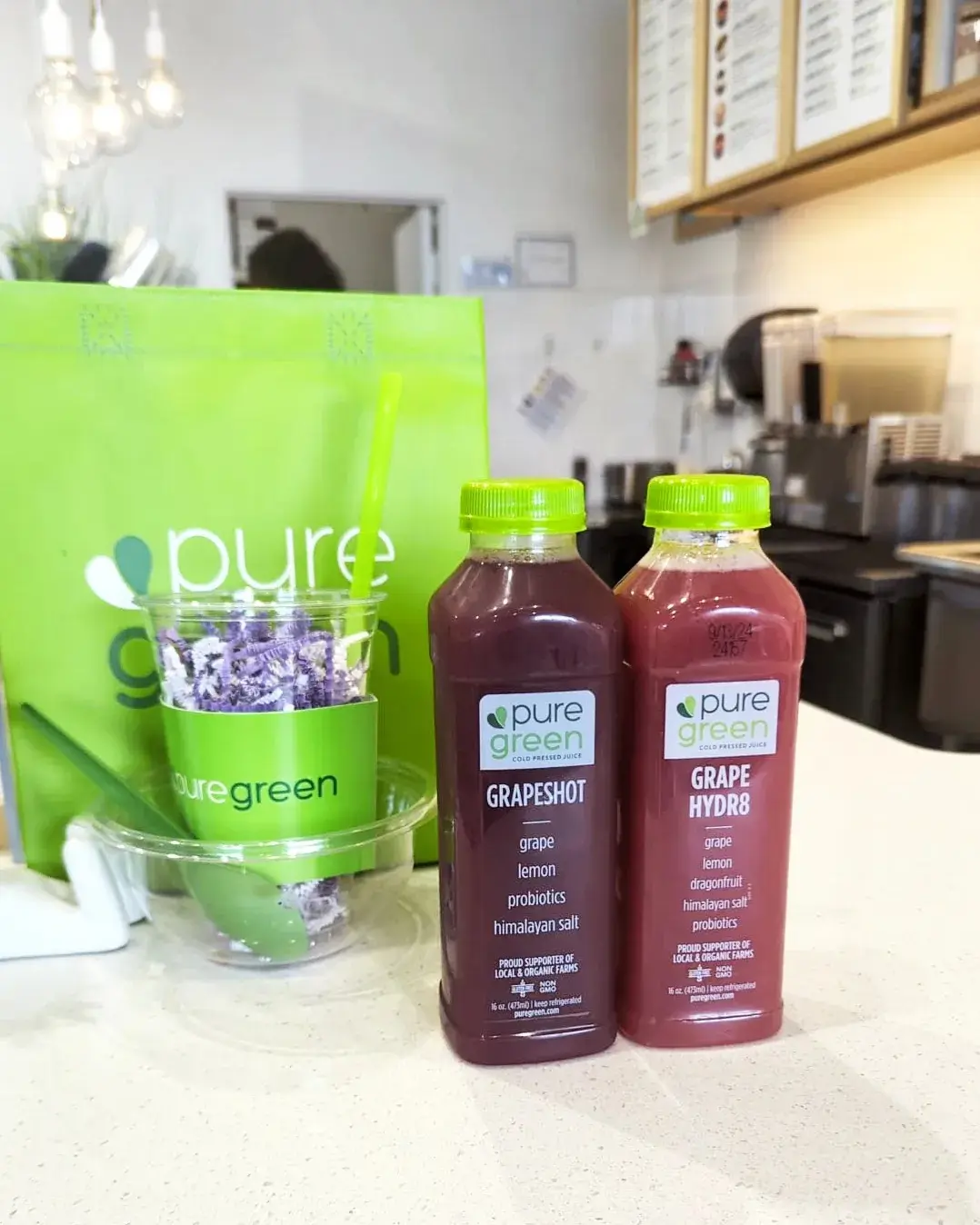 Bottles of Grapeshot and Grape Hydr8 cold-pressed juice on the counter at Pure Green Bridgewater