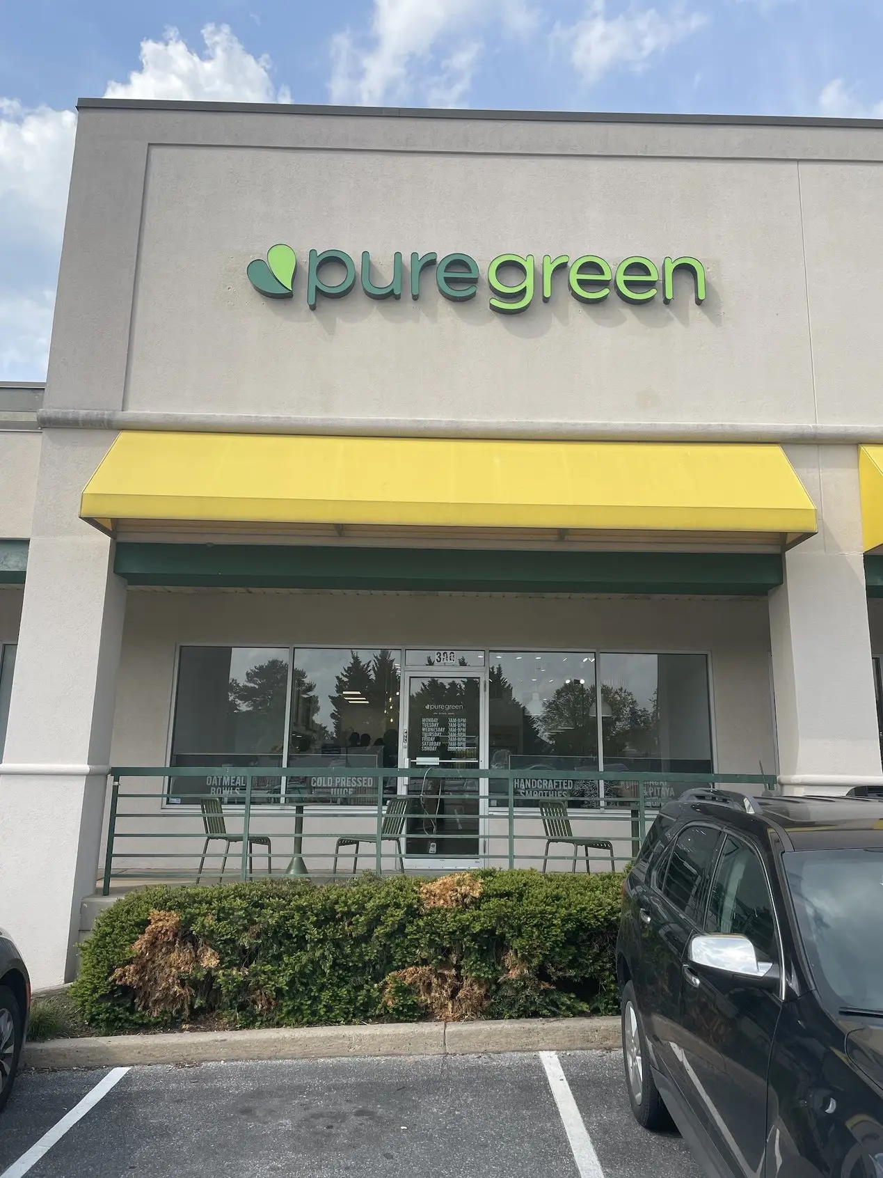 Pure Green Columbia storefront and yellow awning on Dobbin Center Way