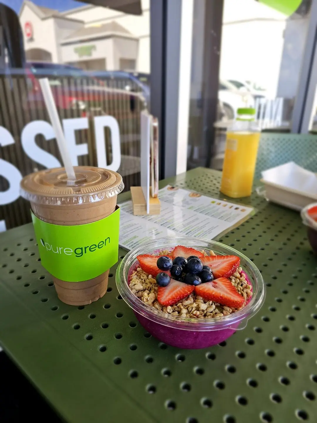 Pure Green smoothie and an acai bowl topped with berries at the Arcadia juice bar