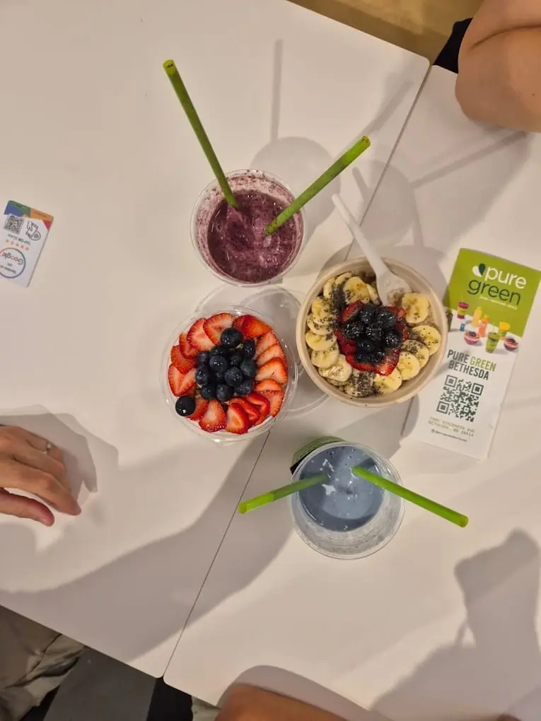 Two acai bowls and two drinks on a table at Pure Green Bethesda