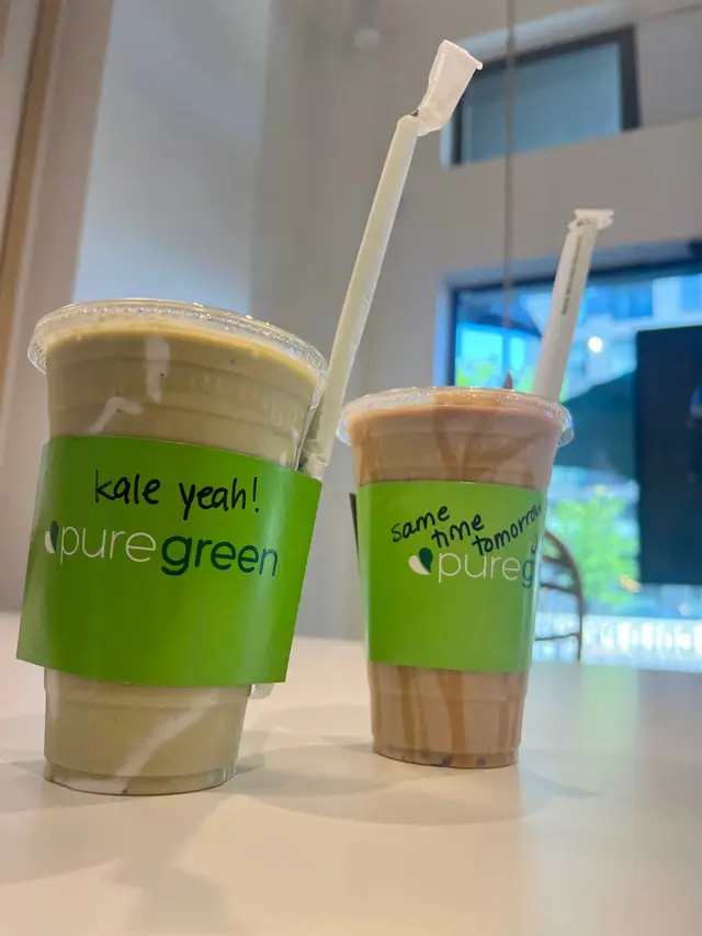 Two Pure Green Park Slope drinks with messages written on the cups