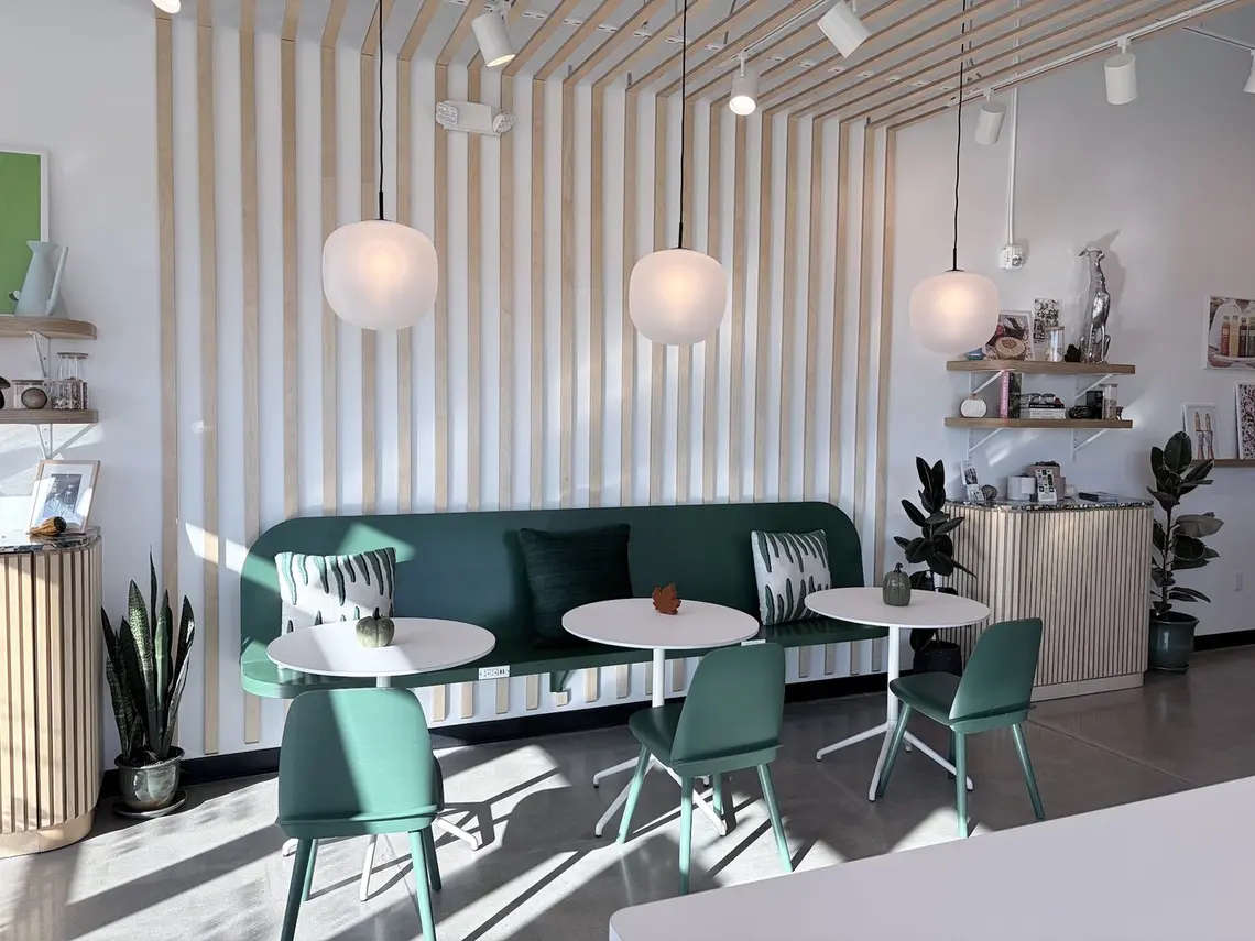 Green banquette seating under the slatted ceiling inside Pure Green Fort Myers