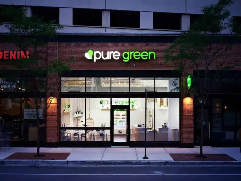 Pure Green Fulton Market storefront on W Fulton Market Street in Chicago at dusk
