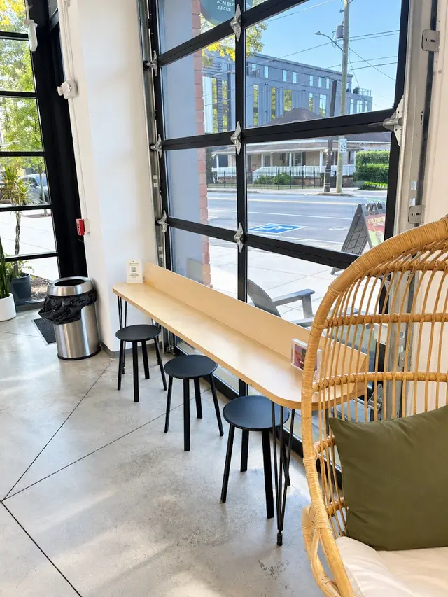 The window bar and stools below the open garage door at Pure Green NoDa
