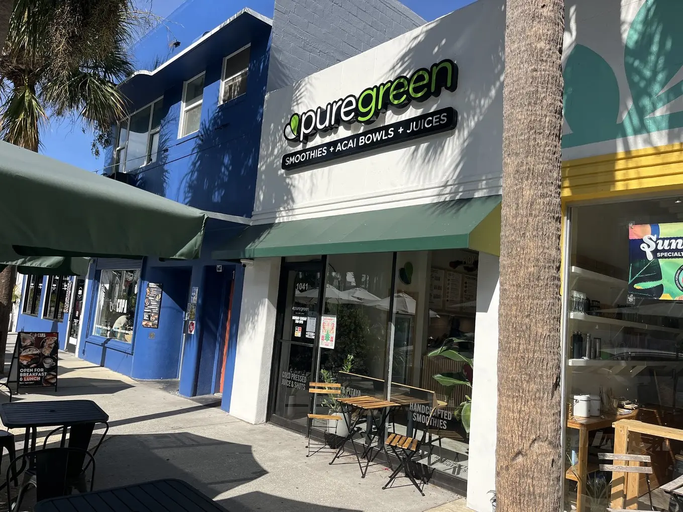 Pure Green St. Pete storefront and patio tables on Central Avenue