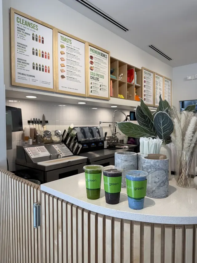 Menu boards above the counter inside Pure Green St. Pete