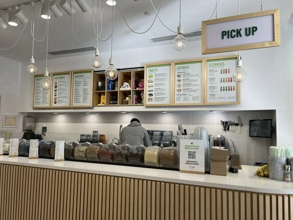 The order counter and menu boards inside Pure Green Buckhead Crossing