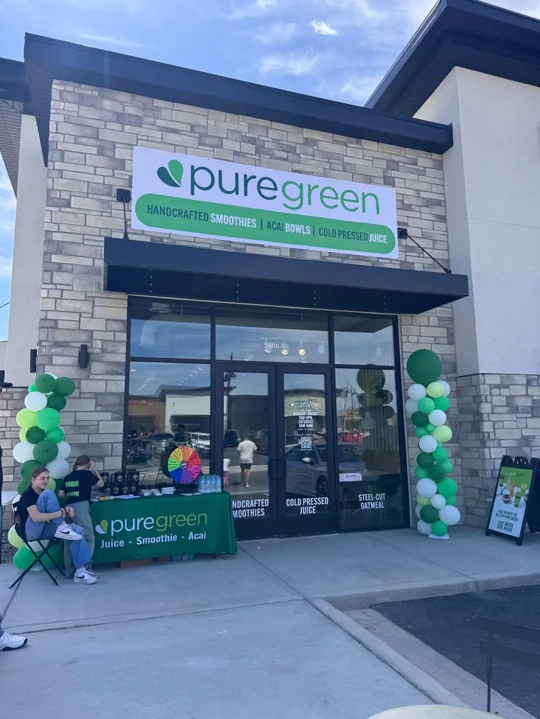 Pure Green Saratoga Springs storefront with grand-opening balloons on Crossroads Boulevard