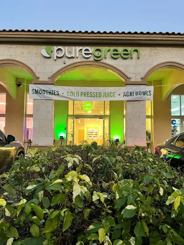 Pure Green Coral Springs storefront lit up in the evening