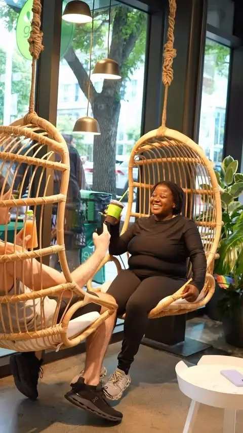 Customer relaxing in a hanging chair at Pure Green Downtown Seattle
