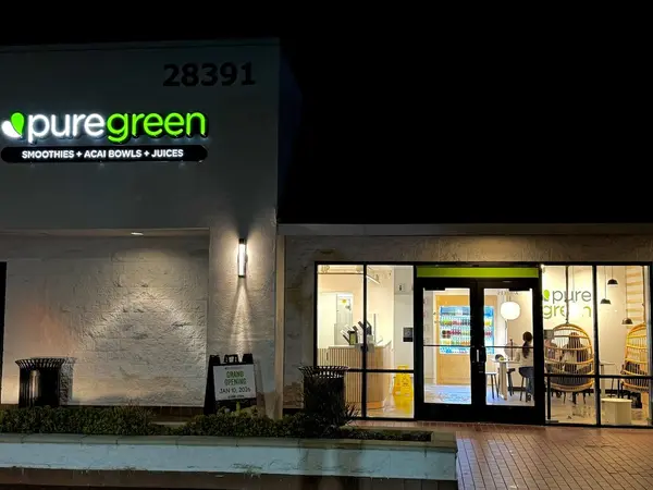 Pure Green Mission Viejo storefront lit up in the evening