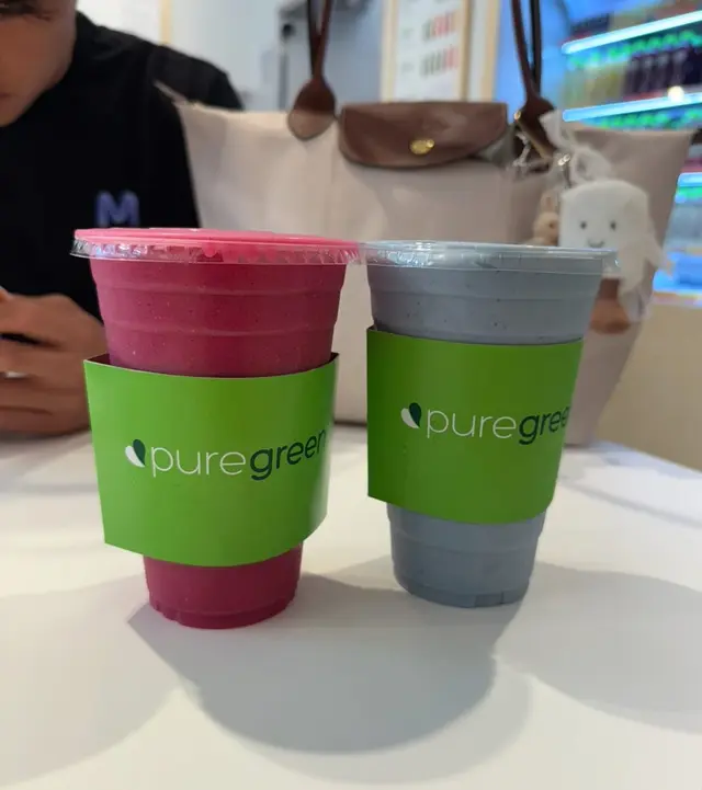 Two Pure Green drinks on the table in the Logan Square store