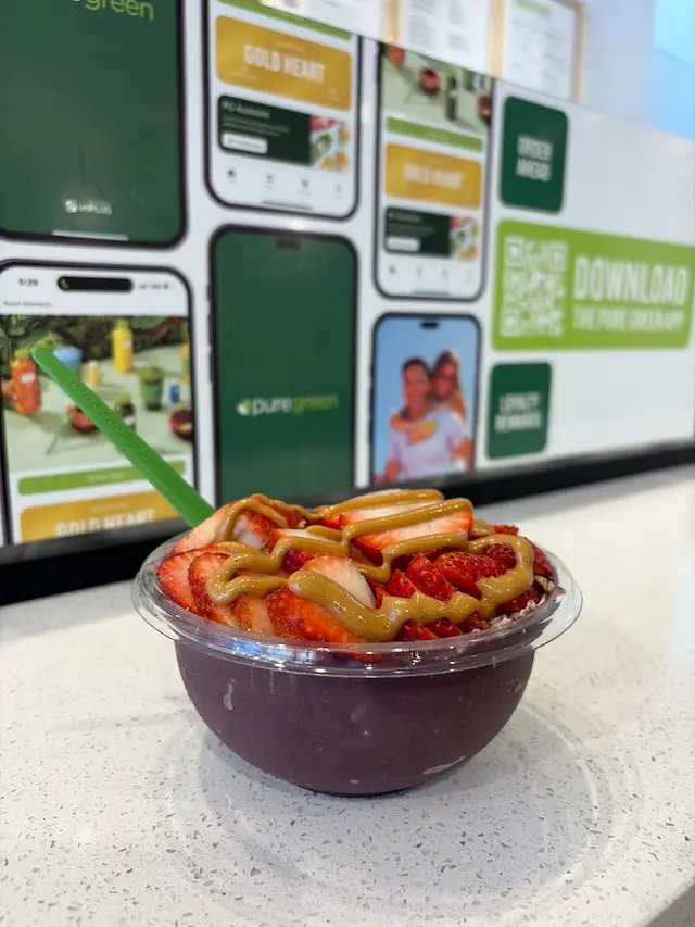An acai bowl topped with strawberries and almond butter at Pure Green Montclair