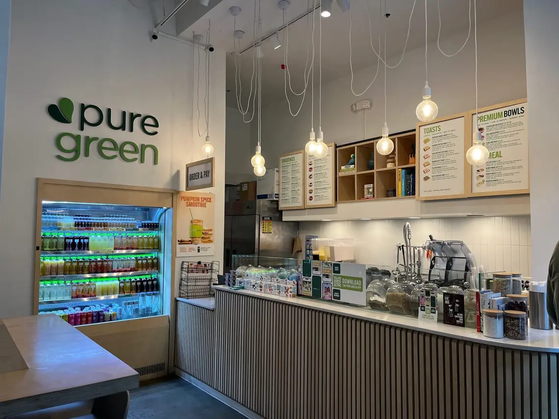 The counter and cold-pressed juice fridge at Pure Green Bed-Stuy