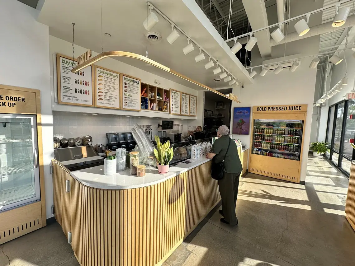 The order counter and cold-pressed juice fridge inside Pure Green South Barrington