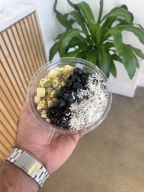 Acai bowl topped with granola and blueberries at Pure Green Mizner Park