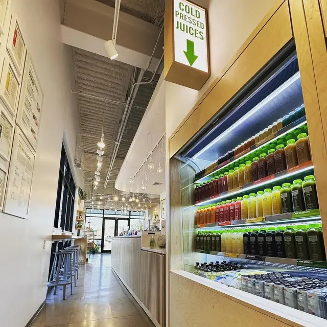 The cold-pressed juice wall inside Pure Green Fort Myers