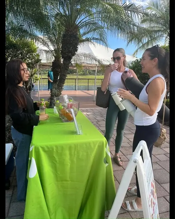 Guests enjoying drinks at a Pure Green Coral Springs pop-up