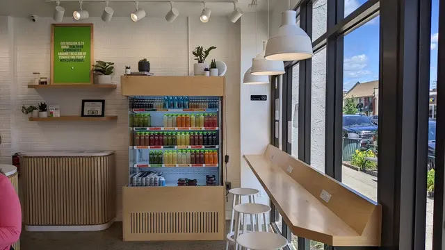 The cold-pressed juice fridge and window bar inside Pure Green Downtown Rochester