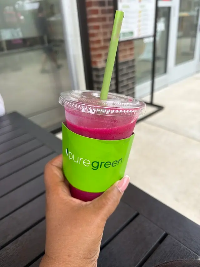A pitaya smoothie on the table outside Pure Green Tysons