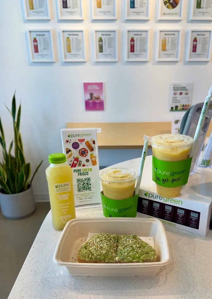 Avocado toast, two smoothies and a bottle of Coconut Hydr8 on the counter at Pure Green Frisco