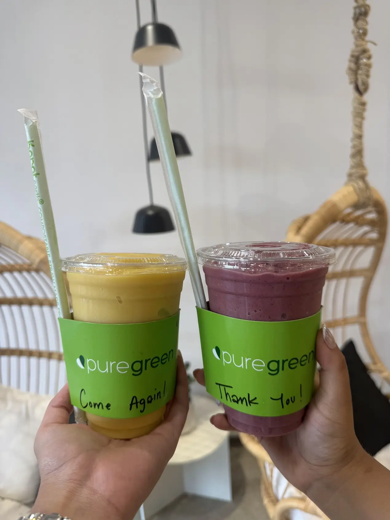 Two smoothies with handwritten notes on the cups at Pure Green Buckhead Crossing