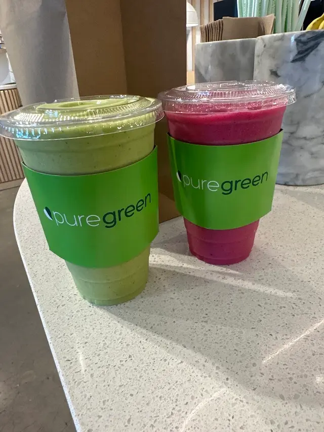 A green smoothie and a pink smoothie on the counter at Pure Green The Woodlands