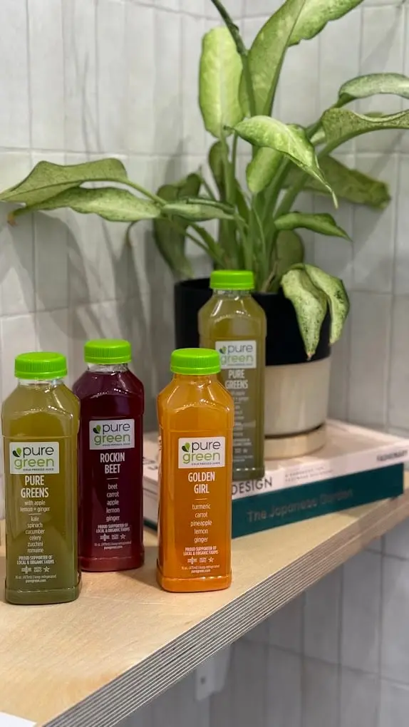 Cold-pressed juice bottles on the shelf at Pure Green Gold Coast