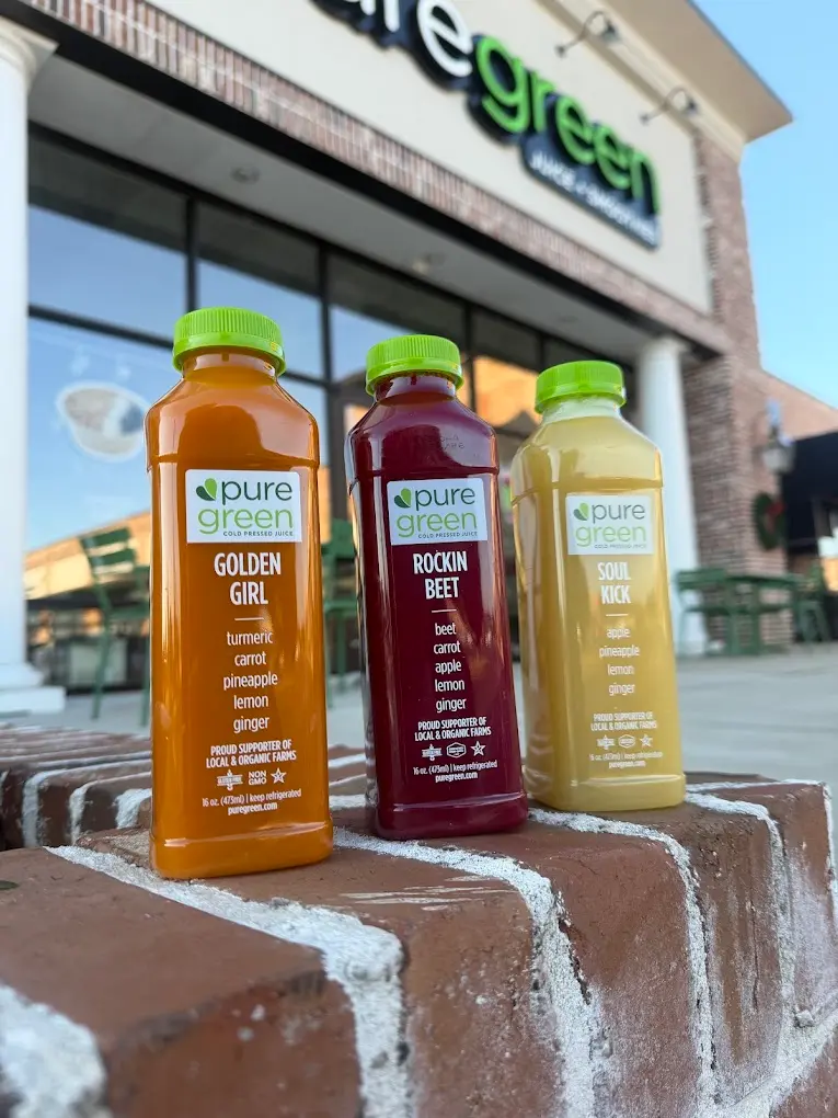 Bottles of Golden Girl, Rockin Beet and Soul Kick cold-pressed juice outside Pure Green Clayton
