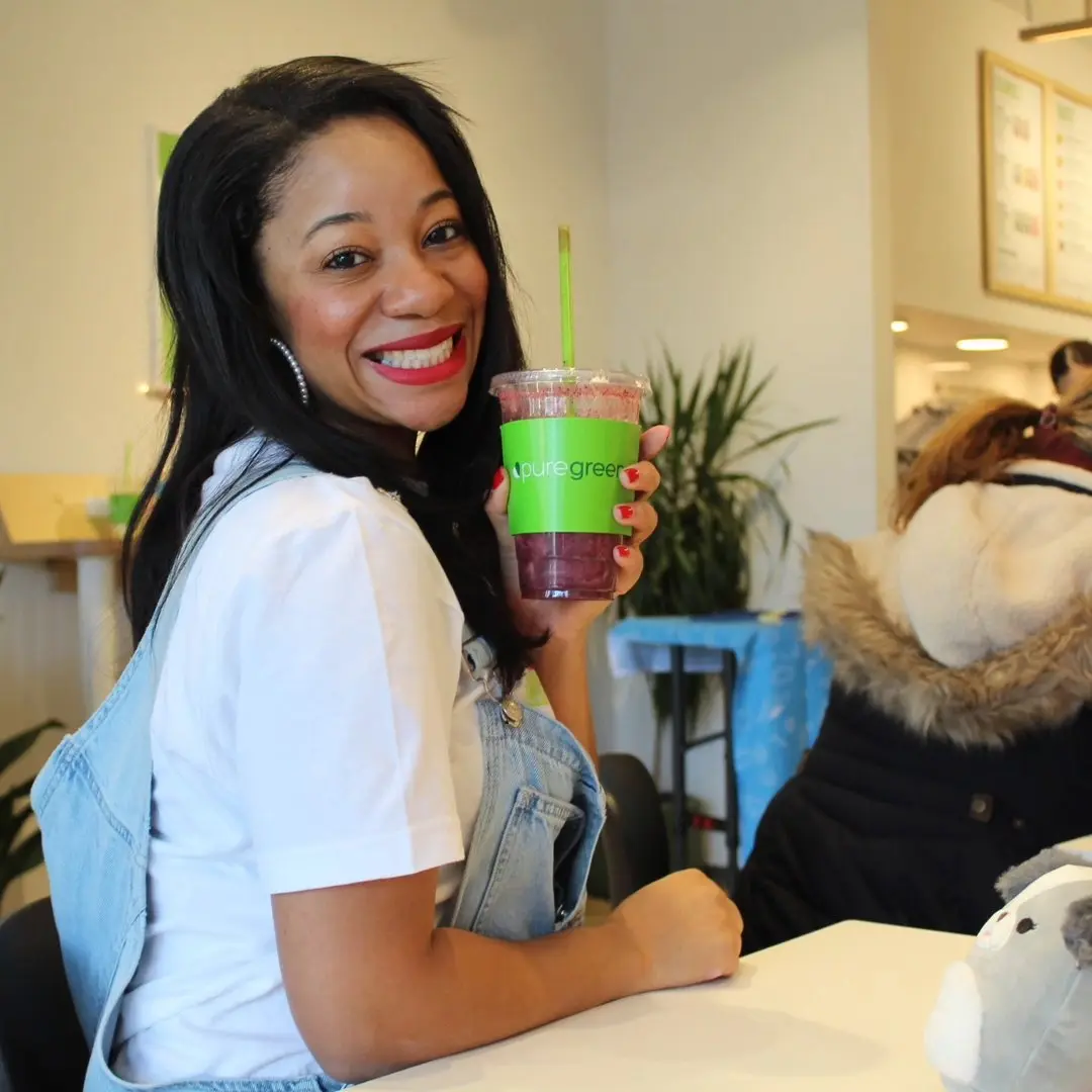 Guest holding an acai bowl inside Pure Green Vienna