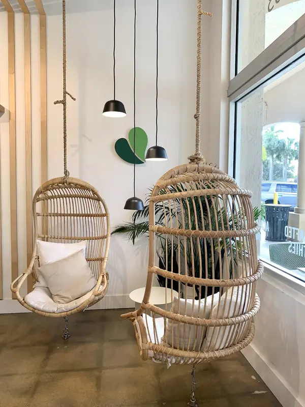Rattan hanging chairs by the window inside Pure Green Coral Springs