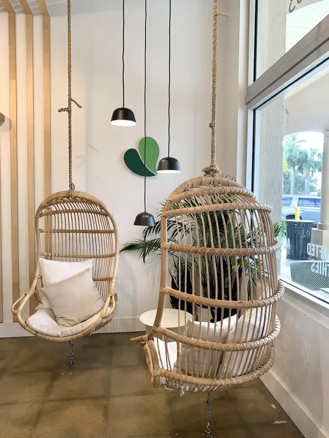 Rattan hanging chairs by the window inside Pure Green Coral Springs
