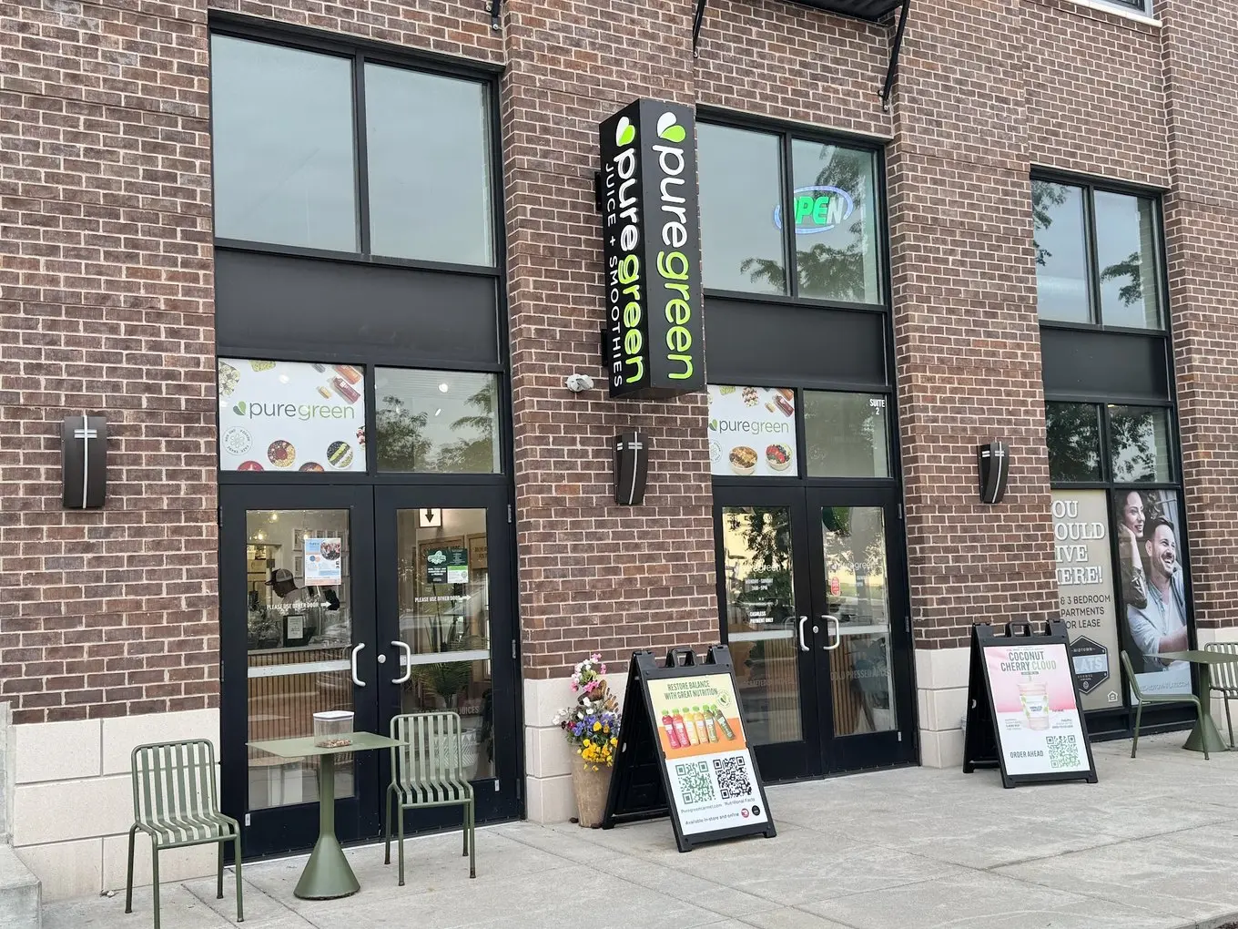 Pure Green Midtown Carmel storefront and patio table on Monon Boulevard