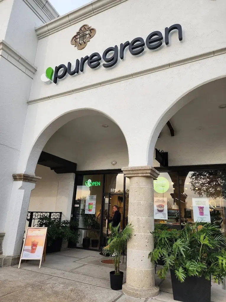 The arched shopfront of Pure Green West University on Westpark Drive