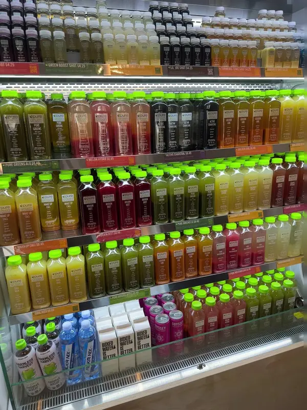 Cold-pressed juice fridge fully stocked at Pure Green Mission Viejo