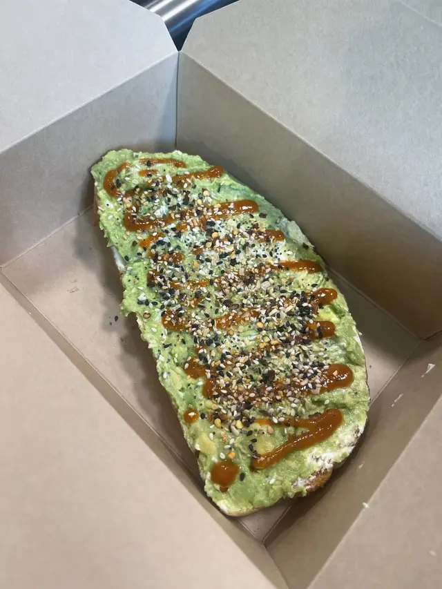 Avocado smash toast in a takeout box at Pure Green Fishers