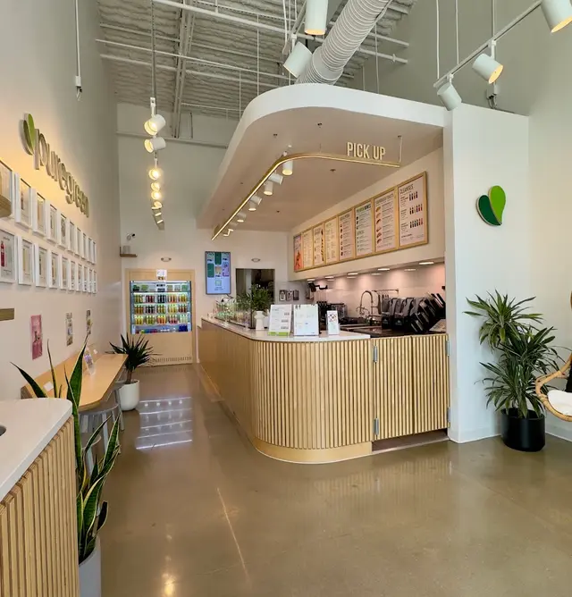 The order counter, menu boards and cold-pressed juice fridge inside Pure Green Frisco