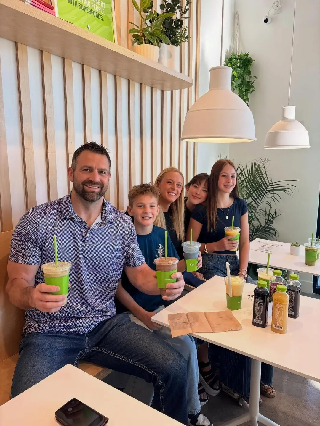Family enjoying green smoothies inside Pure Green Saratoga Springs