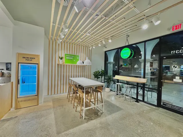 The communal table and online order fridge inside Pure Green West University