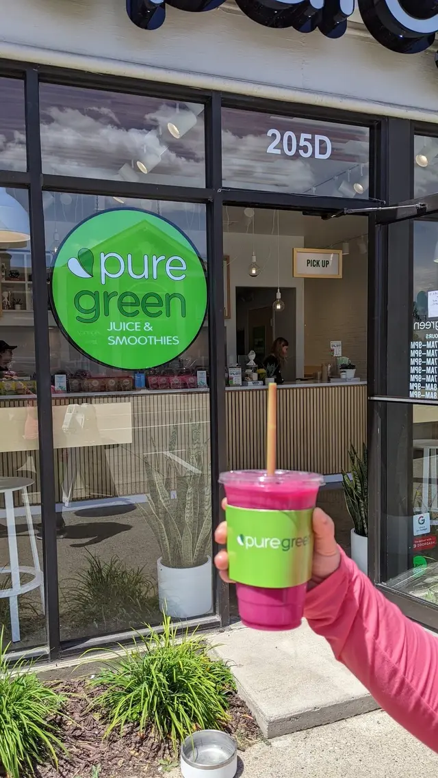 A smoothie held up outside Pure Green Downtown Rochester