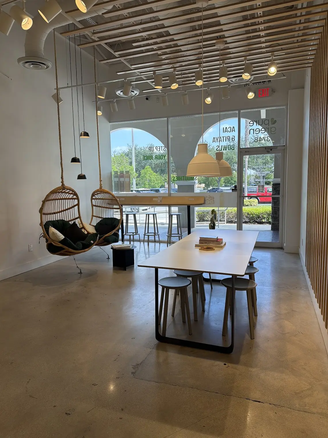 The hanging chair and communal table inside Pure Green Deerfield