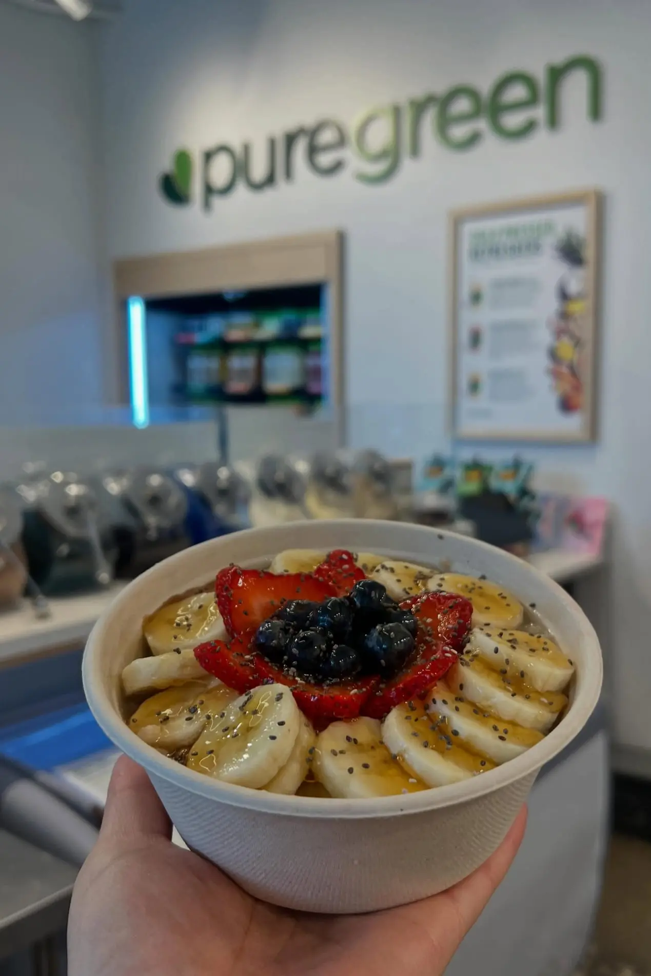 A Chi Chi Chia steel-cut oatmeal bowl held up at Pure Green Park Slope