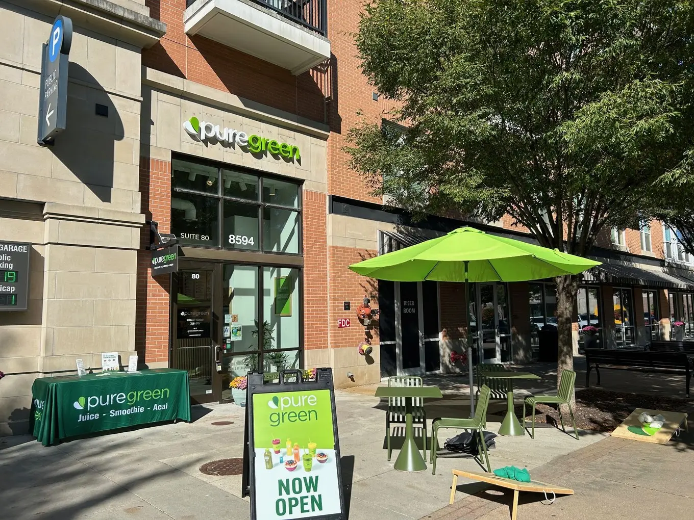 Pure Green Fishers storefront and patio tables in Fishers District