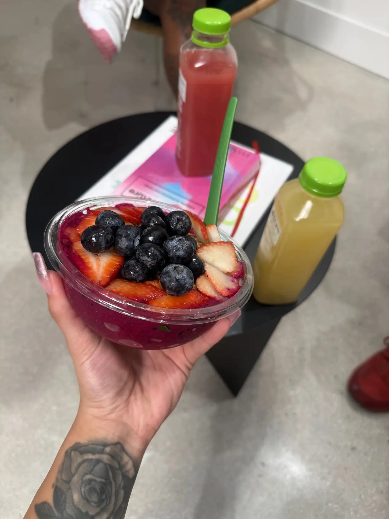 An acai bowl topped with berries and cold-pressed juice at Pure Green Deerfield
